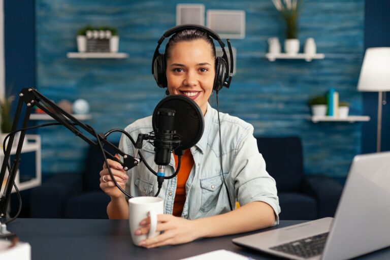 Influencer wearing headphones recording new podcast series at home studio for youtube channel