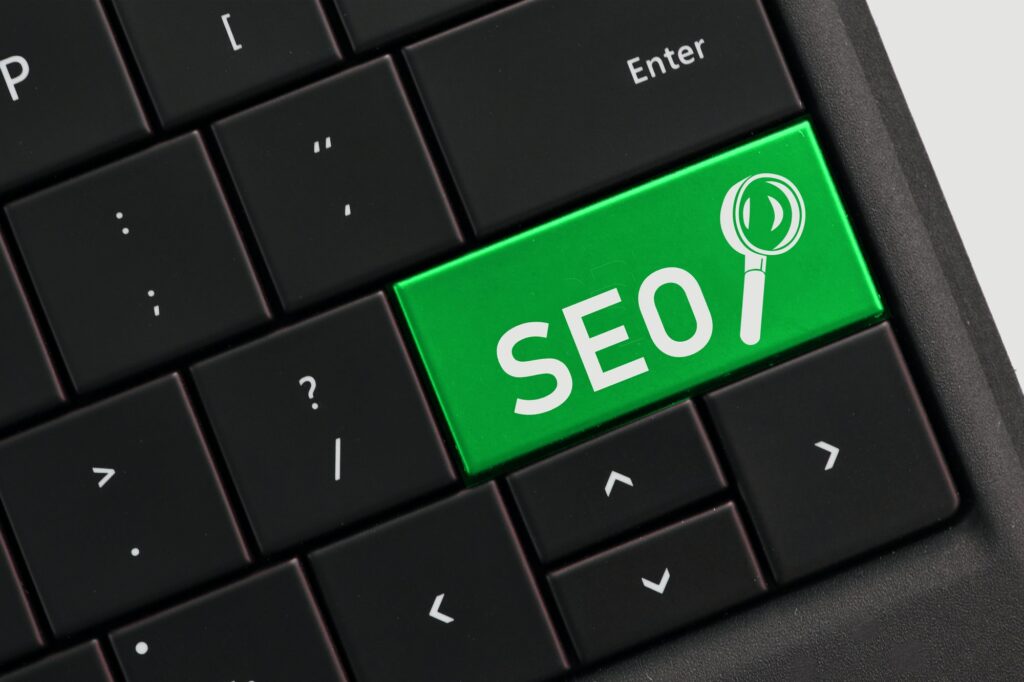 Search engine optimization concept - SEO with magnifying glass on computer key keyboard