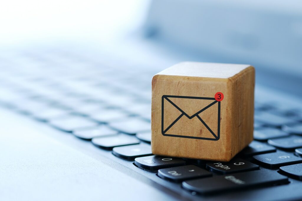 An envelope symbol on a wooden cube on a computer keyboard